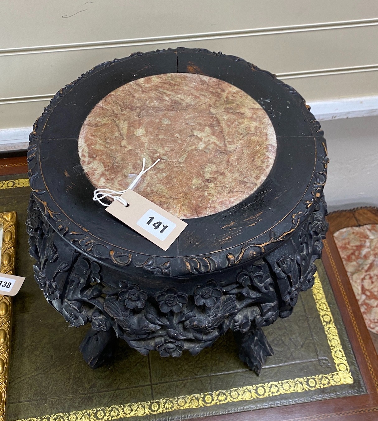 A Chinese circular carved hardwood marble topped jardiniere stand, diameter 38cm, height 35cm